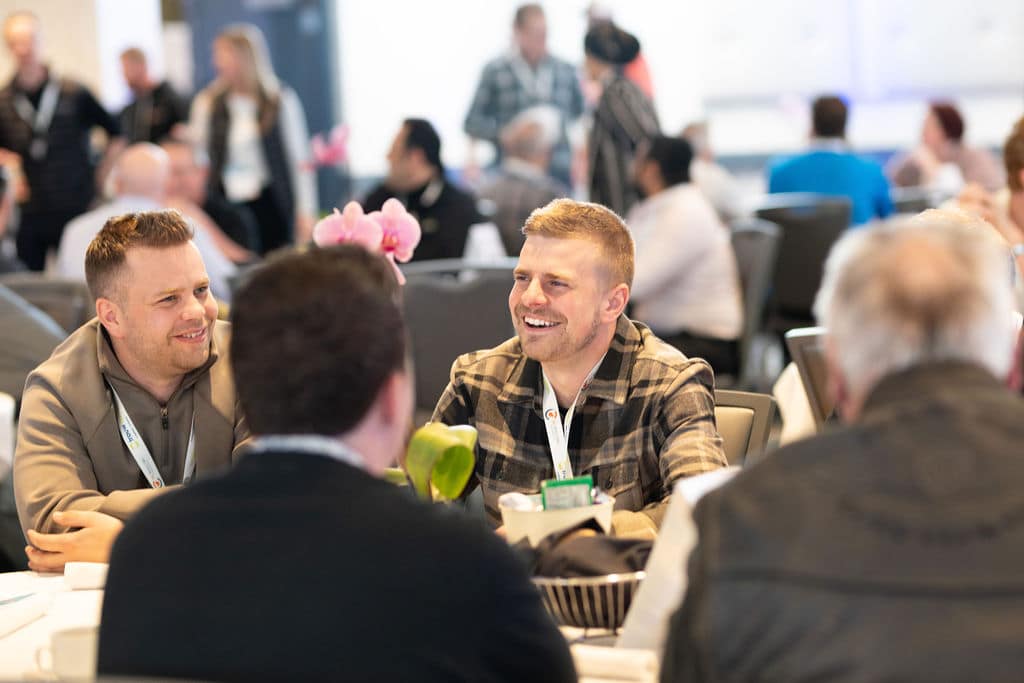 Delegates in conversation around a table at the conference
